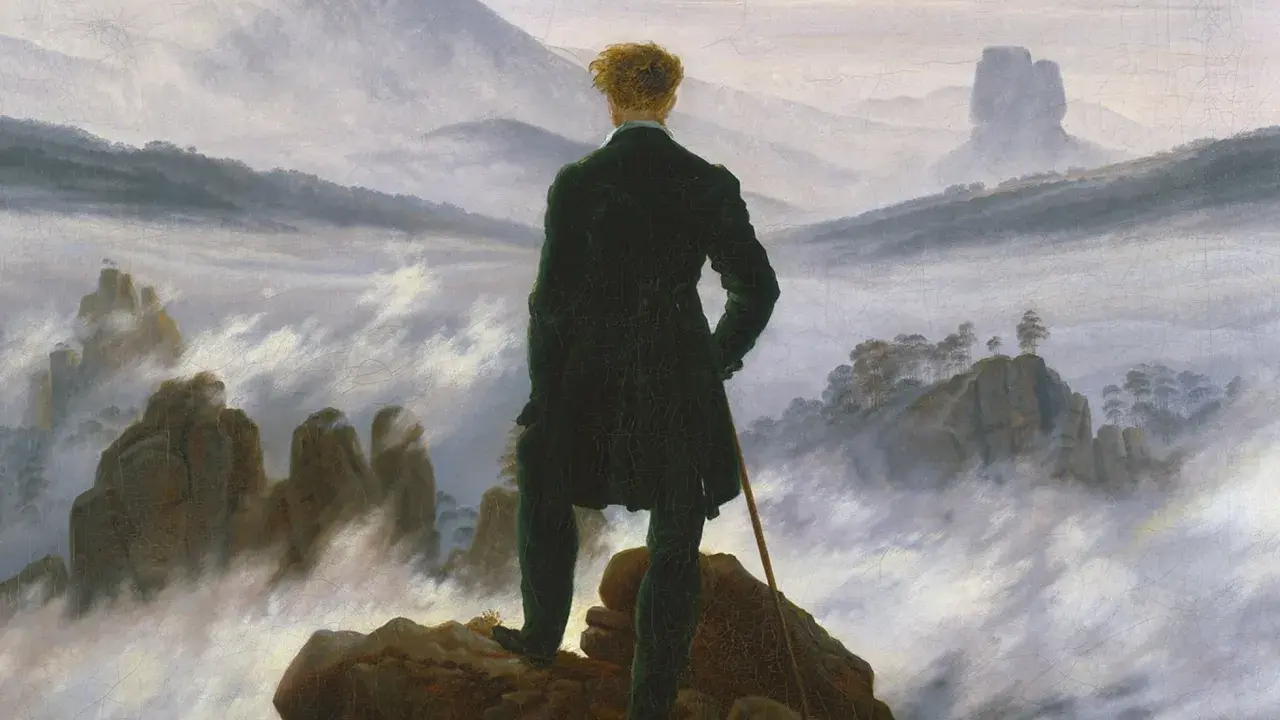 Hombre de espaldas, contemplando un paisaje brumoso y montañoso, al estilo de Caspar David Friedrich.