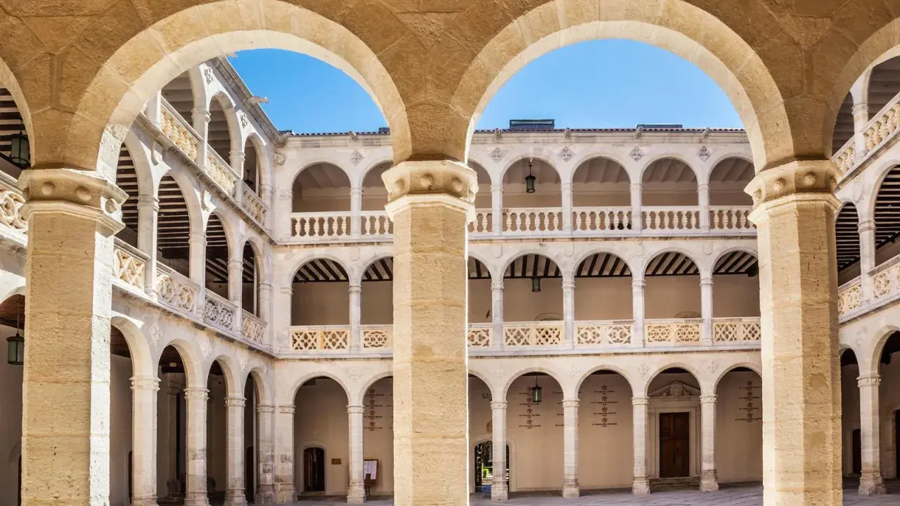 Patio interior con arquerías de varios pisos, columnas y balcones, todo en un elegante estilo renacentista arquitectura.