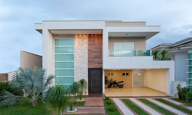 Una casa moderna con líneas limpias y materiales mixtos, que muestra la diversidad de los tipos de casas del mundo.