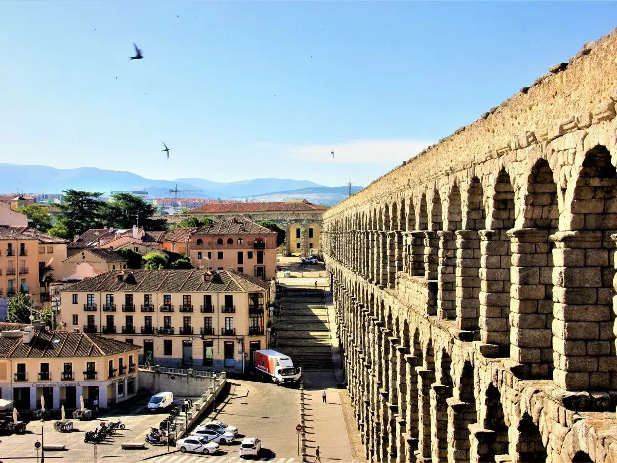 El acueducto romano de Segovia, un ejemplo de architectural styles antiguos, se alza majestuoso sobre la ciudad.